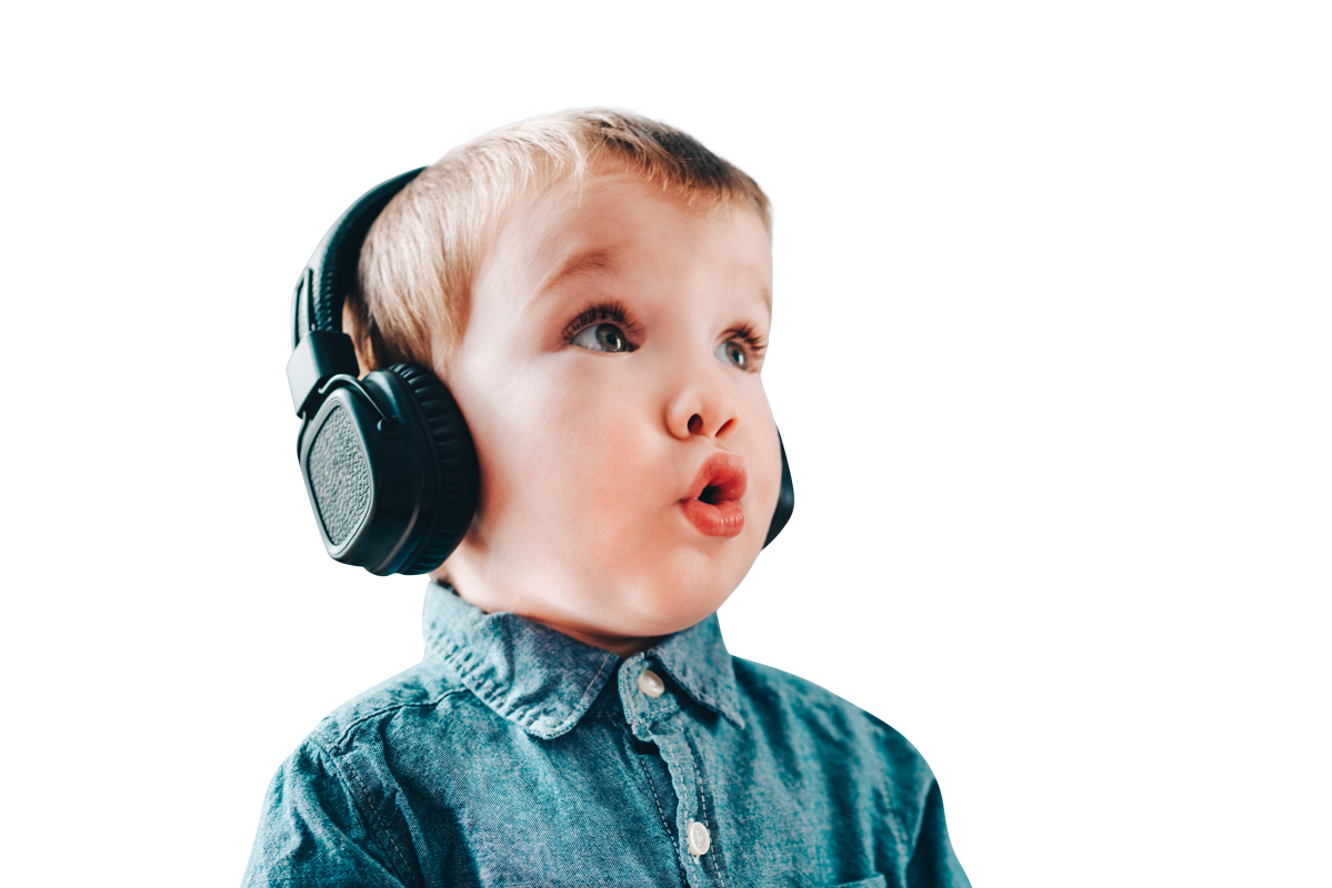 Young boy wearing black headphones looking pleasantly surprised.